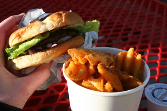Fanci Freez's huckleberry burger, seasoned waffle fries, and fry sauce.
