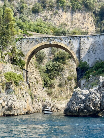 The Fjordo di Furore stone bridge leads to a hidden beach on the Amalfi Coast.