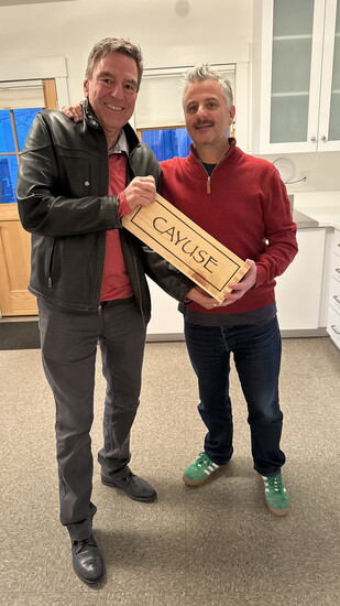 Christophe Baron and Jan de Weerd sharing a special bottle from Cayuse — a reflection of vision realized.