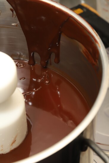 Step one is to pour heated cream over chocolate to make the "truffle guts."