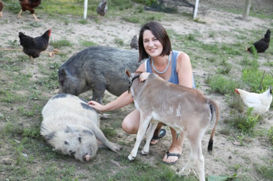 Kimberly scratches Pumbaa's belly with Belle and Stewie by her side