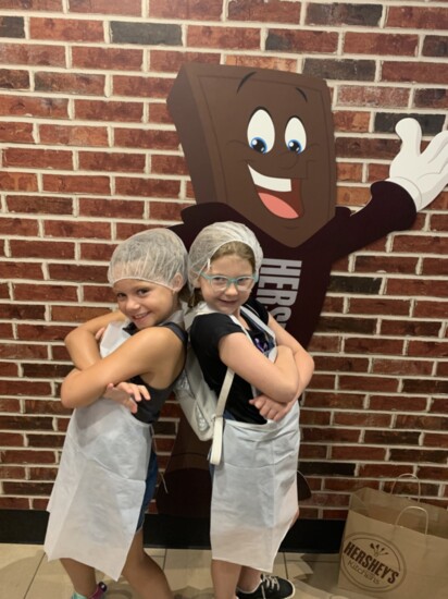 Charlotte and her friend, Scarlett, in gear for the Create Your Own Candy Bar Attraction