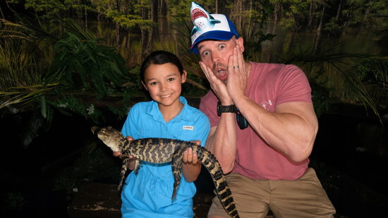 Molly Martin, left, shares a wildlife moment with her dad, Orry Martin, whose love for reptiles has become a family language.