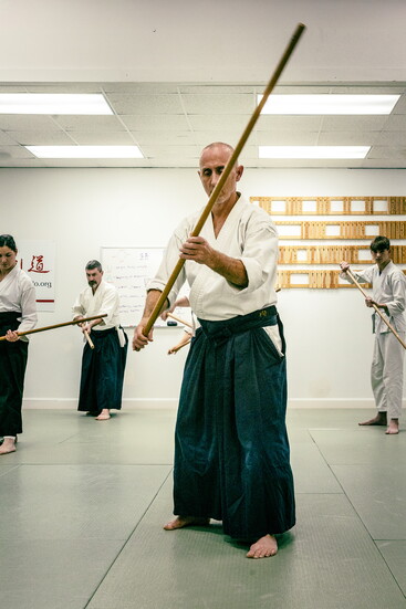 Focused training at the Portsmouth Aikido Dojo, with students moving in unified rhythm