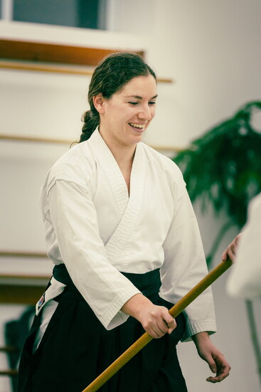 A student refines their technique with calm intention and steady posture