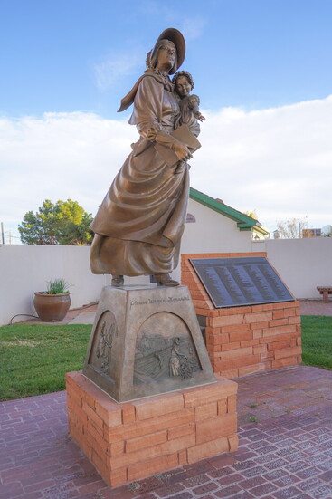 Womens Pioneer Memorial at the Relief Society Hall. Beind the statue is a list pioneer women names.