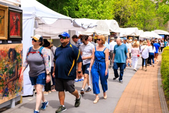 Festivalgoers stroll by amazing artwork created by the world's finest artists.