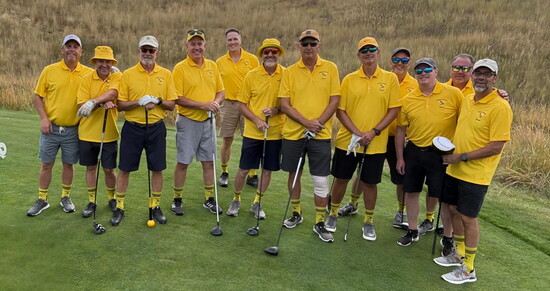 Men of the jacket show off their matching yellow polos in 2025, their 12th year.