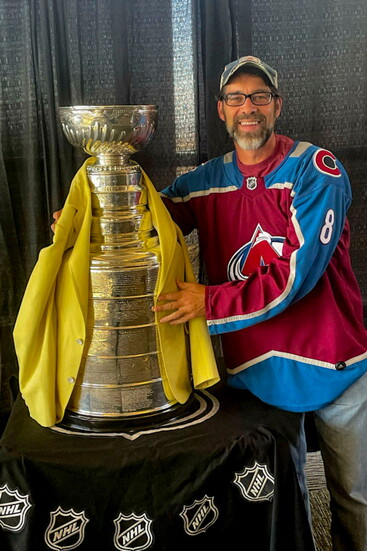 Brian Geraghty drapes the Stanley Cup with the jacket after the Avs win the Championship.
