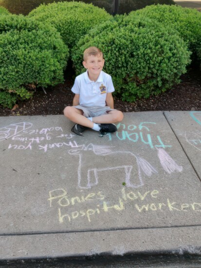 A student shows his appreciation for Little Man through sidewalk chalk art.