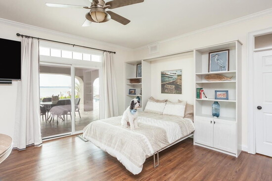 Voila! This bed folds up between the custom bookcases when the guests have left.