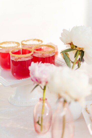 The gold sugar rim adds an elegant touch to the Prickly Pear & Rose Lemonade.