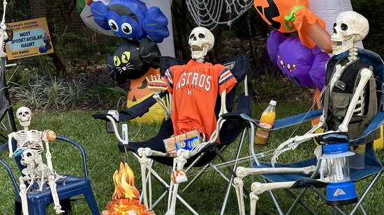 There's a lot of fall fun goin' on with skeletons around the bonfire.