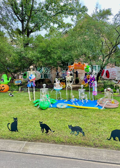 Poolside fun includes skeleton pets and black cats.