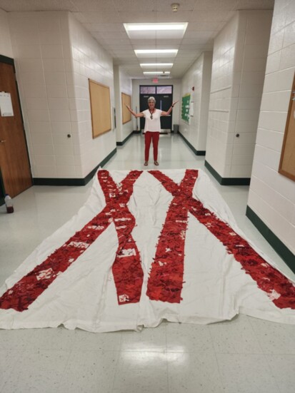 Peggy Thomas with the Rochester banner