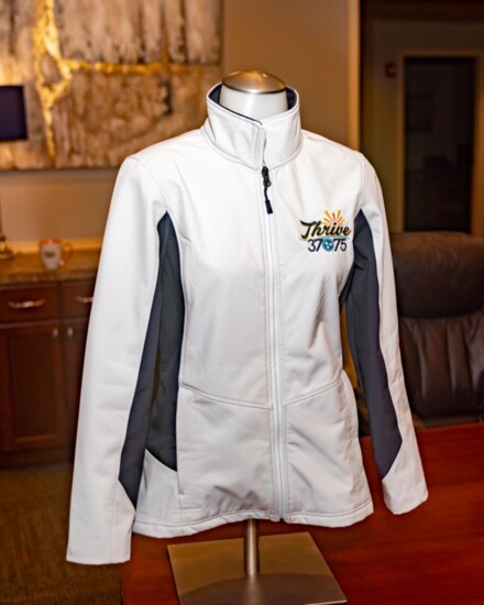 A ladies jacket with the embroidered Thrive logo