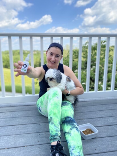 Tiffany Lewis and her Shih Tzu, Millie, show off The Pleasant Pet hemp oil that Tiffany's company offers.