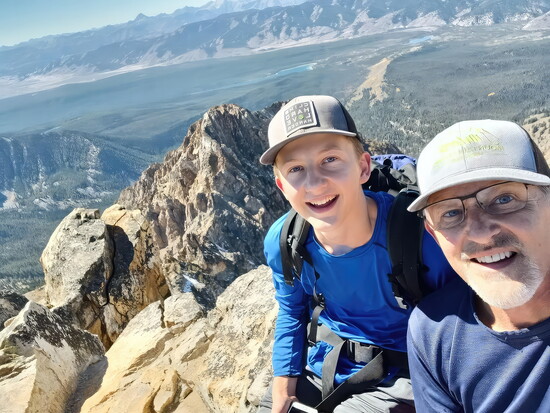 Summit of Thompson Peak with youngest son Sam, Sawtooth Range. Low risk.