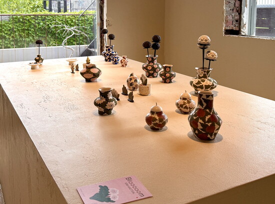 A showcase of ceramic pottery lends a gallery feel to Delphic teahouse.