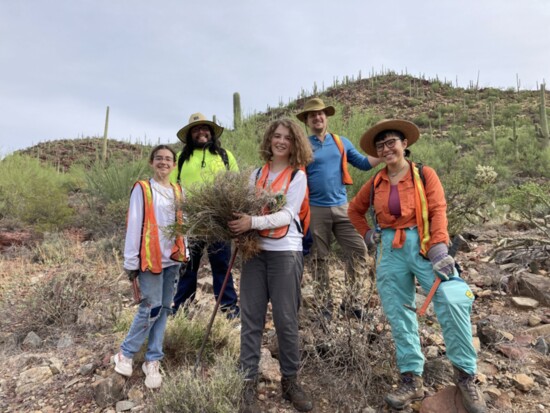High school volunteers hauling out the grass trash