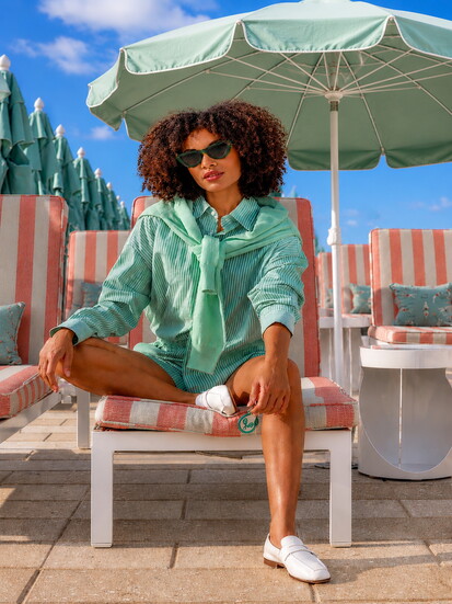 Aniya in The Lady & The Sailor x Marissa Collections Flutter Shirt & Short, Mish Cashmere Pullover, and Bottega Veneta Cat Eye Sunglasses