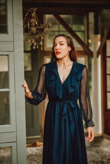 Flowing ruffles, diaphanous sleeves, and a tie waist serve ballerina vibes in this 1970s navy cocktail dress. (Unlabeled, model’s own)