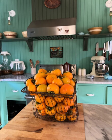 A basket of fresh persimmons on the counter of the Swimming Buck Farm kitchen