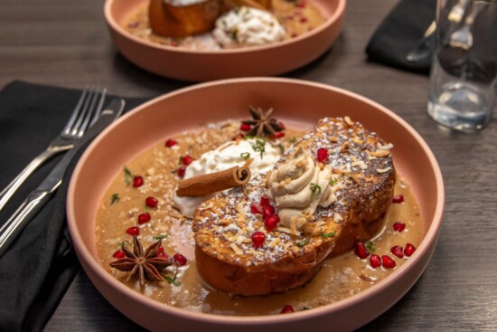 Coquito French Toast: Coquito batter on Challah bread, coconut flakes, pomegranate seeds with coquito and honey-infused whipped cream. DeMartinoLatin.com