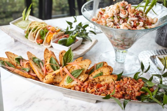 Crostini with tomato bruschetta, mini tacos, seafood salad