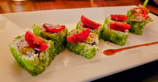 Grinch: Yellowtail, seared albacore tuna, basil, cucumber, spicy sauce, green tempura bites, cherry tomato, and balsamic-soy.