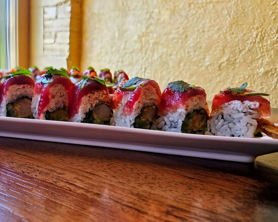 Tuna Cilantro: Tempura shrimp, cucumber, topped with snowcrab, tuna, lime, chili-garlic sauce, and cilantro.