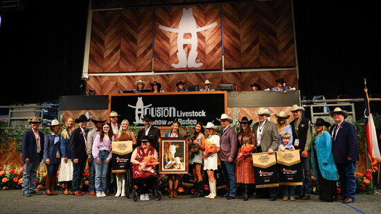 A painting by Sophie Zhou, at center holding painting, sold for $276,000 at the Houston Livestock Show and Rodeo. Photo courtesy of HLSR.