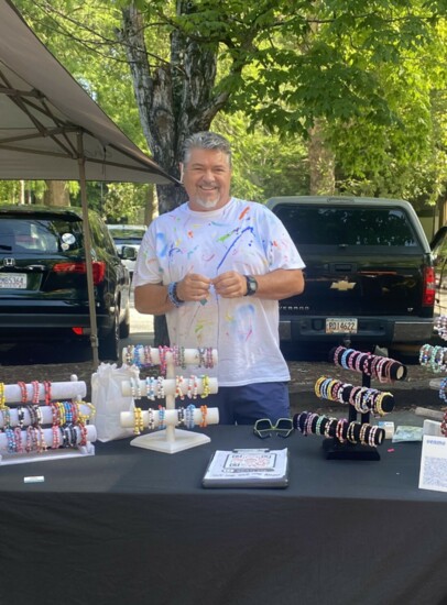 Jay sells bracelets at local market