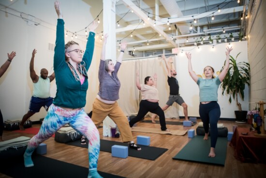 Students strike a pose during a class at Total Practice Yoga.