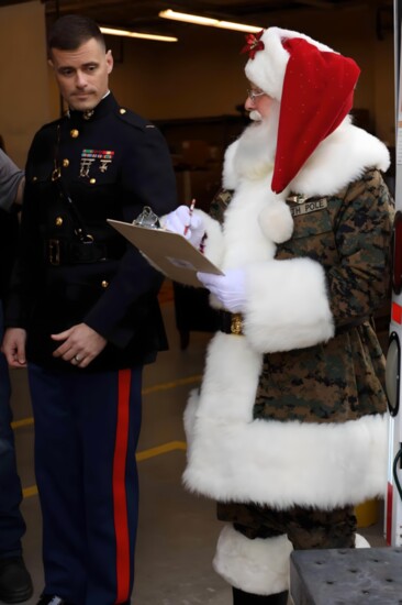 Santa makes his list with the help of friend.