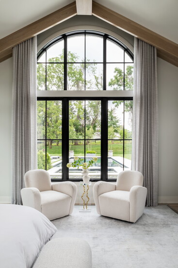 Architectural focal points, like arched windows, provide framed views of private landscapes, integrating nature into the daily experience.