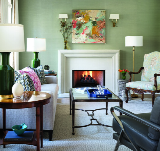In the formal living room, a mix of old and new furnishings adds depth, while a Windy O’Connor painting hangs above the fireplace, flanked by sconces updated 