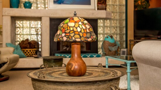 A John Yurosko sea glass lamp. Pictured behind the lamp is Bermuda, where John collected the individual pieces.