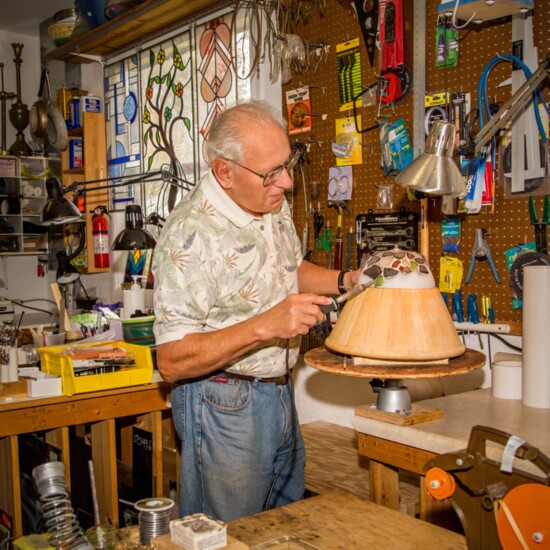 The artist at work in his studio. John collects the glass and creates the forms so that every lamp is one-of-a-kind.