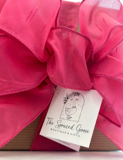 A beautiful pink bow and an example of the immaculate gift wrapping The Spruced Goose offers