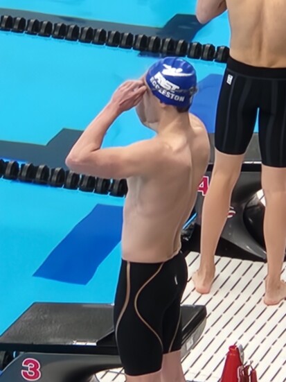 Jake adjusting his goggles behind the blocks at Junior Nationals in Chicago. 