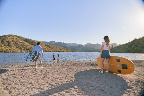 Family paddleboarding and swimming at Saguaro Lake