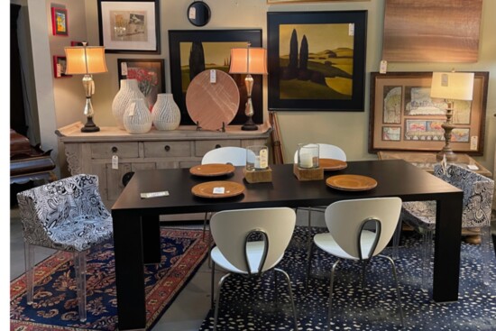A minimalist dining table flanked with modern black and white chairs. Photo:John Clark