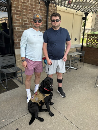 Gabe Heefner with his dog Allie and Bryan Pieschel, Director of Veteran Services at Dogs for Our Brave.