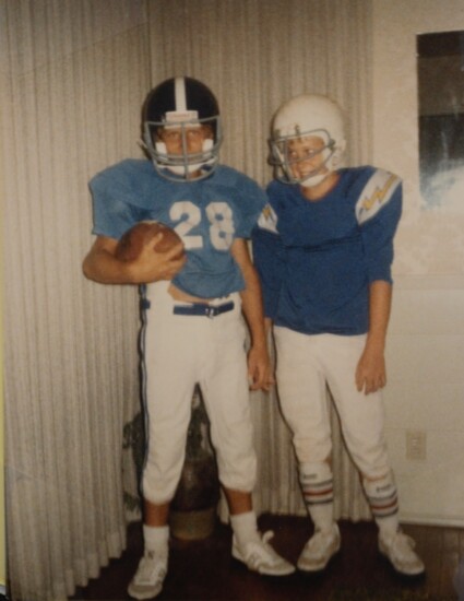 A young Tyler with friend, Joseph Bricky, dressed up in their older brothers' football gear