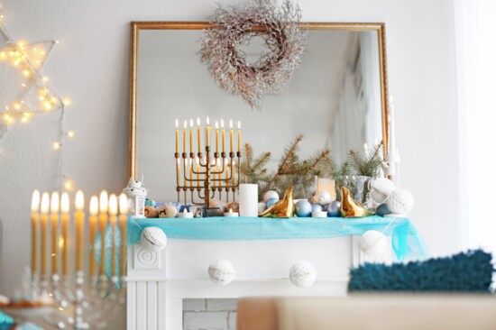 Decorate a beautiful fireplace for Hanukkah as an additional gathering spot.