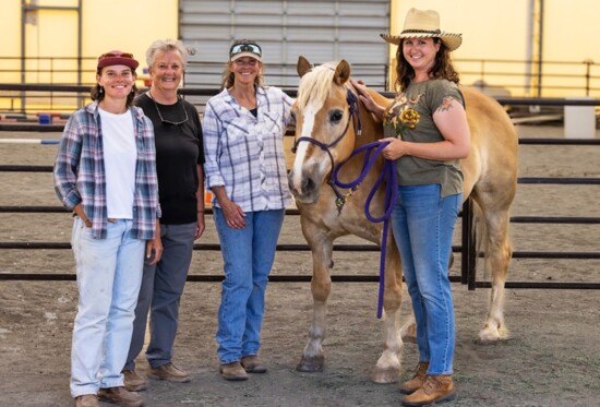 Lynne Howarth and Karen Finch (middle) enjoy a quiet moment with Goldie the horse and other staff at the Center. 