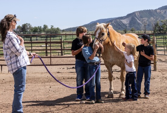 Karen Finch (left) watches on as children connect with Goldie.