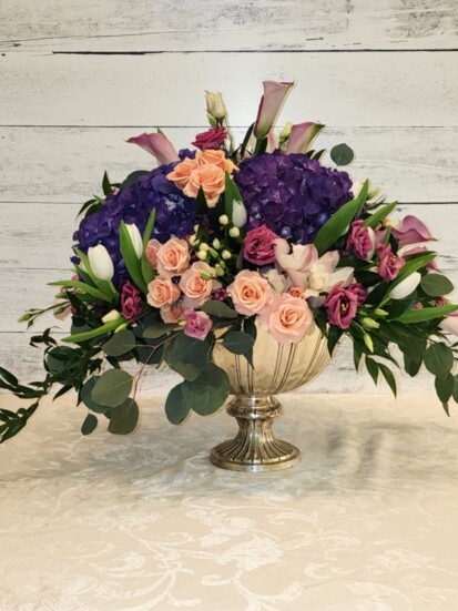 Jeannine Diamond of Wyckoff Florist & Gifts designed this spring-dash-inspired arrangement of Hydrangea, Mini Calla Lilies, Orchids, Tulips, and Lisianthus