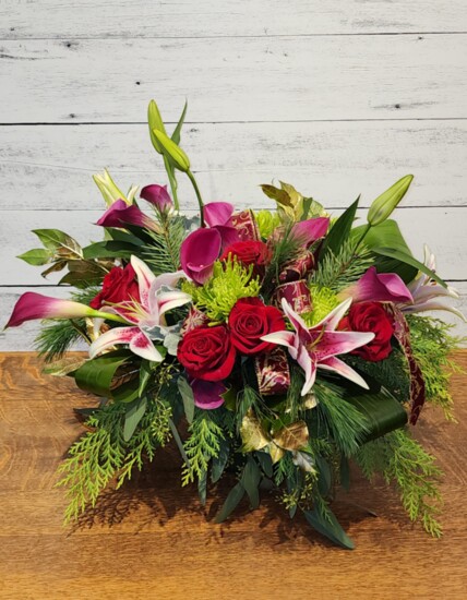 Fran Lauretta of Creations by Fran Flowers & More created this cube arrangement consisting of Roses, Mini Calla Lilies, Stargazer Lilies, Cedar, and more